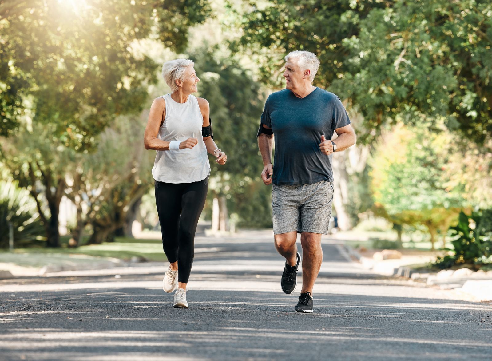 Active older couple jogging together